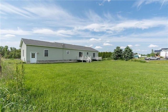 30656 Nys Route 37, Le Ray, NY 13637 - back of house featuring a wooden deck and a lawn