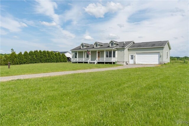 30656 Nys Route 37, Le Ray, NY 13637 - view of front of house with a porch, an attached garage, a front lawn, and driveway