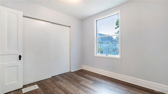 63 Briggs Ave, Buffalo, NY 14207 - unfurnished bedroom featuring dark wood finished floors and a closet