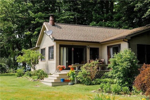 3271 Lanning Rd, Spafford, NY 13152 - rear view of house with a chimney, a lawn, and roof with shingles