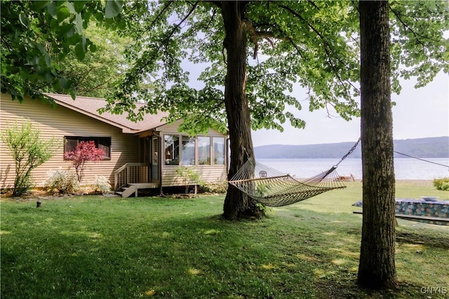 3271 Lanning Rd, Spafford, NY 13152 - view of green lawn featuring a sunroom and a water view