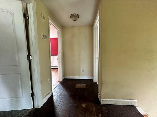 55 Maple St, Canisteo, NY 14823 - hallway featuring dark wood-type flooring and a baseboard heating unit