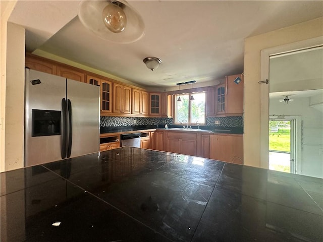 55 Maple St, Canisteo, NY 14823 - kitchen featuring stainless steel appliances, glass insert cabinets, decorative backsplash, and brown cabinetry