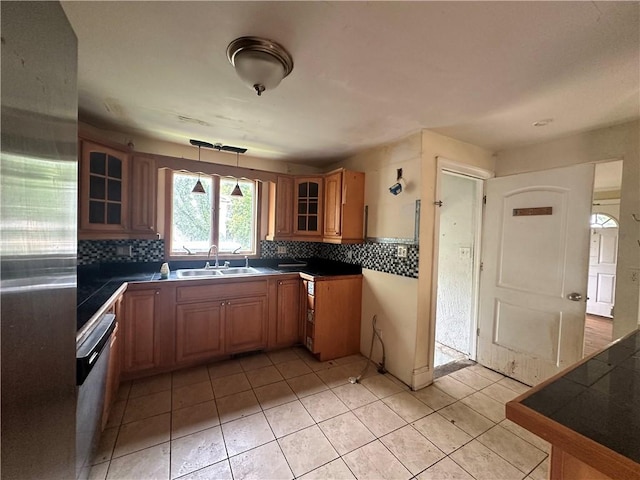 55 Maple St, Canisteo, NY 14823 - kitchen featuring appliances with stainless steel finishes, decorative backsplash, glass insert cabinets, brown cabinetry, and light tile patterned floors