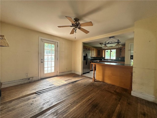 55 Maple St, Canisteo, NY 14823 - kitchen with stainless steel fridge with ice dispenser, dark countertops, light wood-style floors, ceiling fan, and a peninsula