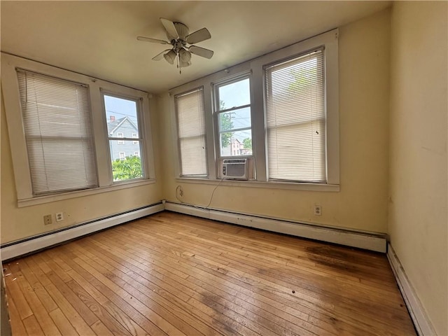 55 Maple St, Canisteo, NY 14823 - empty room with wood-type flooring, plenty of natural light, ceiling fan, and a baseboard radiator