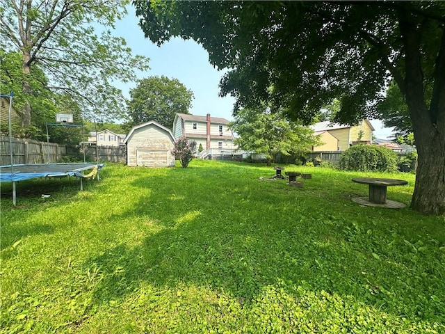 55 Maple St, Canisteo, NY 14823 - fenced backyard featuring a storage unit and a trampoline
