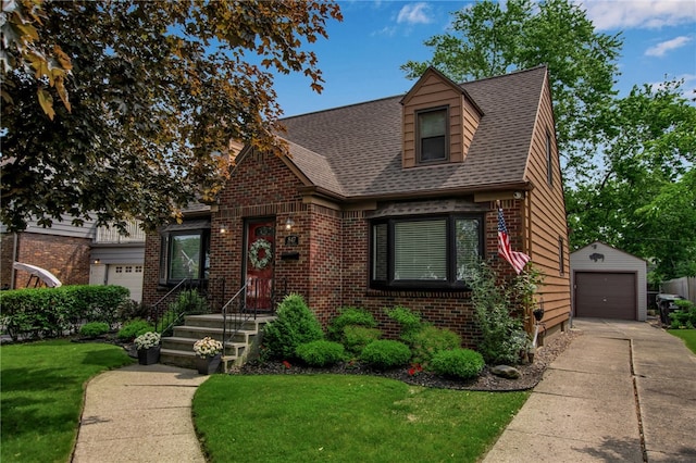 847 Starin Ave, Tonawanda-Town, NY 14223 - view of front of home featuring brick siding, a front lawn, a detached garage, concrete driveway, and an outdoor structure