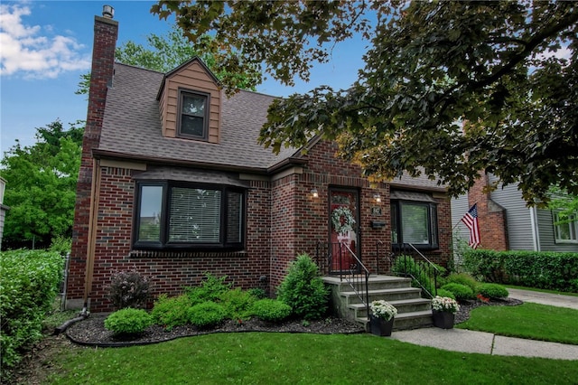 847 Starin Ave, Tonawanda-Town, NY 14223 - view of front of home with brick siding, a chimney, a front lawn, and a shingled roof