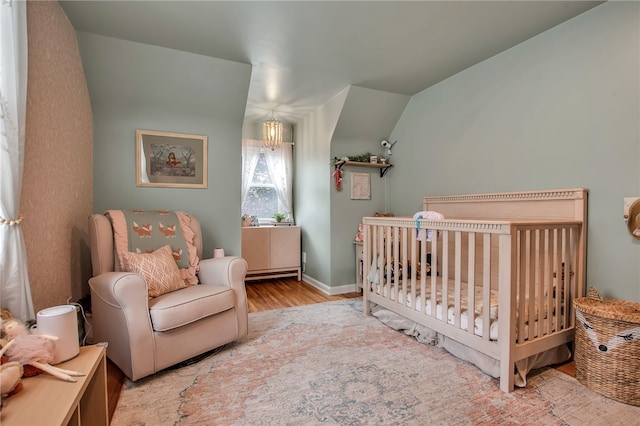 847 Starin Ave, Tonawanda-Town, NY 14223 - bedroom featuring wood finished floors, a nursery area, and lofted ceiling