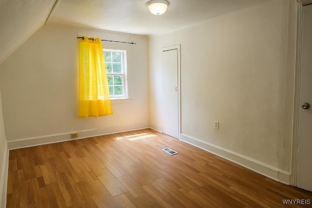 165 Leroy Ave, Buffalo, NY 14214 - spare room featuring wood finished floors and vaulted ceiling
