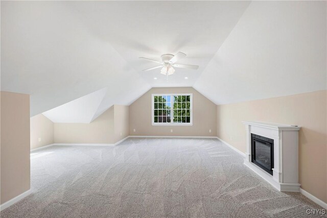 4244 County Line Rd, Skaneateles, NY 13152 - bonus room featuring carpet floors, a ceiling fan, lofted ceiling, and a glass covered fireplace