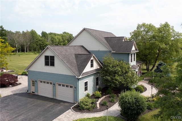 4244 County Line Rd, Skaneateles, NY 13152 - view of home's exterior featuring asphalt driveway, a shingled roof, an attached garage, and a lawn