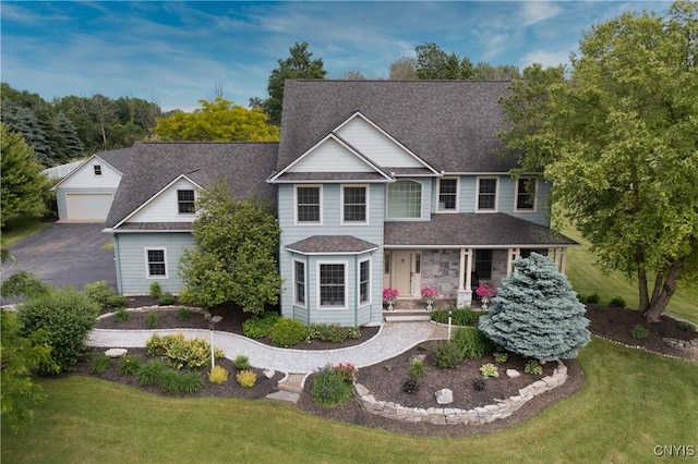 4244 County Line Rd, Skaneateles, NY 13152 - view of front of house featuring a front yard, covered porch, an outdoor structure, and a shingled roof