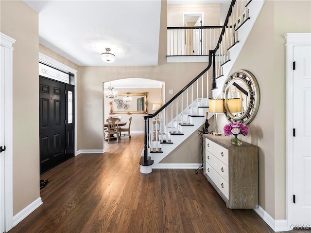 4244 County Line Rd, Skaneateles, NY 13152 - foyer entrance featuring stairway, wood finished floors, arched walkways, and a chandelier
