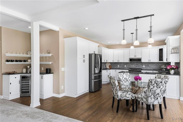 4244 County Line Rd, Skaneateles, NY 13152 - kitchen featuring beverage cooler, stainless steel appliances, dark countertops, backsplash, and white cabinets