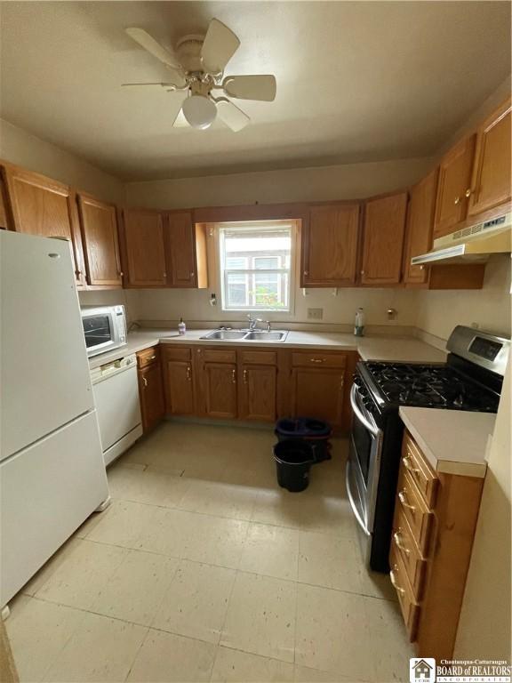 102 Broadhead Ave, Jamestown, NY 14701 - kitchen with white appliances, under cabinet range hood, light countertops, brown cabinets, and a ceiling fan