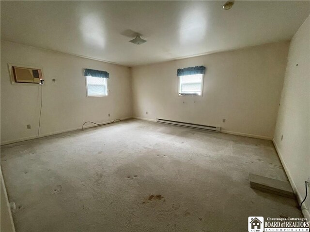 102 Broadhead Ave, Jamestown, NY 14701 - spare room with a baseboard radiator, a wall mounted AC, and carpet floors