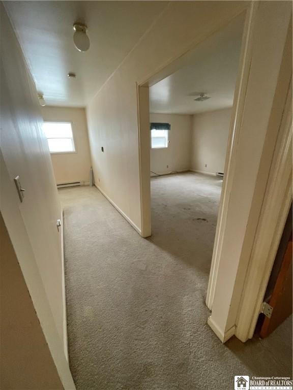 102 Broadhead Ave, Jamestown, NY 14701 - hall with light colored carpet, healthy amount of natural light, and baseboard heating