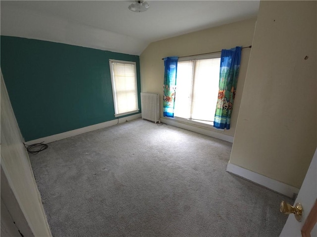 17 Lake St, Mount Morris, NY 14510 - empty room featuring radiator, lofted ceiling, and carpet flooring