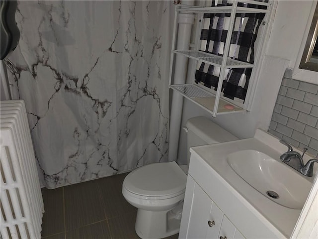 17 Lake St, Mount Morris, NY 14510 - full bath featuring radiator, vanity, a shower with shower curtain, tile patterned floors, and tile walls