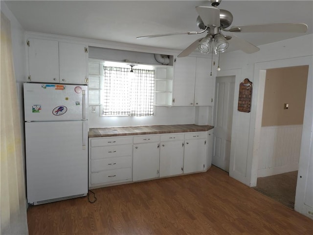 17 Lake St, Mount Morris, NY 14510 - kitchen featuring freestanding refrigerator, ceiling fan, white cabinetry, wood finished floors, and a wainscoted wall