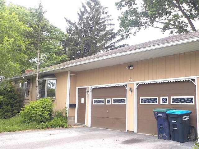 6 Newport Rd, Irondequoit, NY 14622 - view of property exterior with driveway and roof with shingles