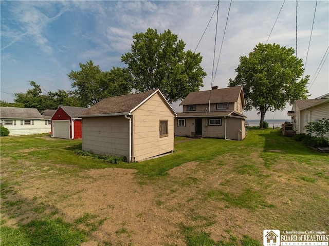 3971 Rte 430, Ellery, NY 14712 - back of house featuring a detached garage, an outbuilding, and a yard