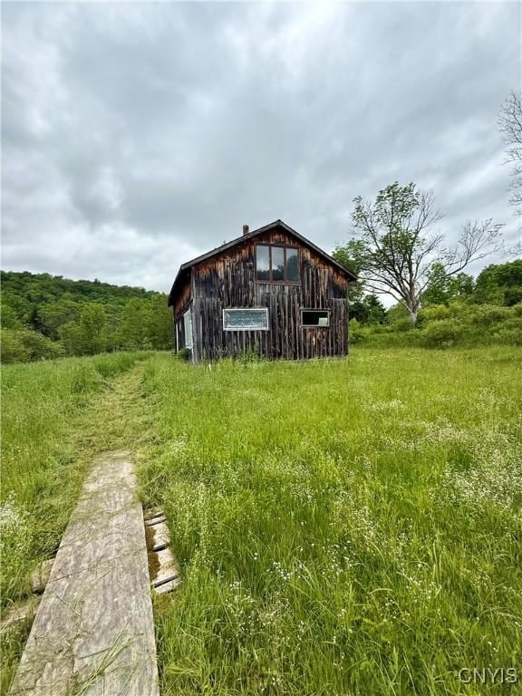 301 Pigeon Hill Rd, Plymouth, NY 13844 - rear view of house featuring a barn and an outbuilding