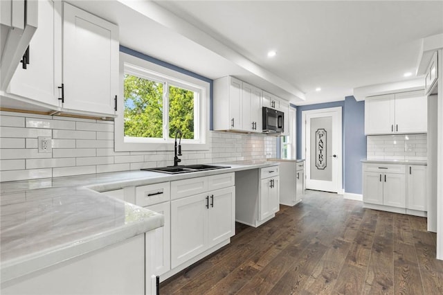 4709 Freeman Rd, Royalton, NY 14105 - kitchen featuring black microwave, tasteful backsplash, dark wood-style flooring, recessed lighting, and white cabinets