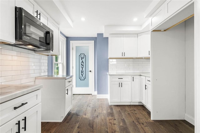4709 Freeman Rd, Royalton, NY 14105 - kitchen with black microwave, backsplash, dark wood finished floors, light countertops, and recessed lighting