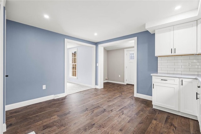 4709 Freeman Rd, Royalton, NY 14105 - kitchen with dark wood-style floors, light countertops, white cabinets, decorative backsplash, and recessed lighting