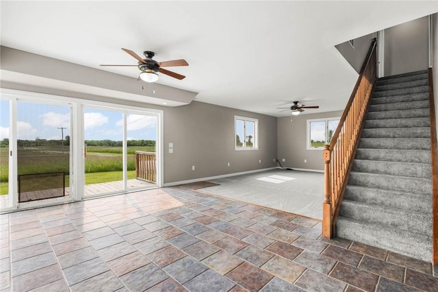 4709 Freeman Rd, Royalton, NY 14105 - unfurnished living room with ceiling fan, stone finish flooring, and stairs
