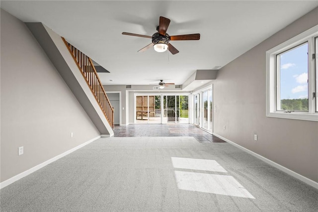4709 Freeman Rd, Royalton, NY 14105 - unfurnished living room featuring a ceiling fan, carpet, stairway, and healthy amount of natural light