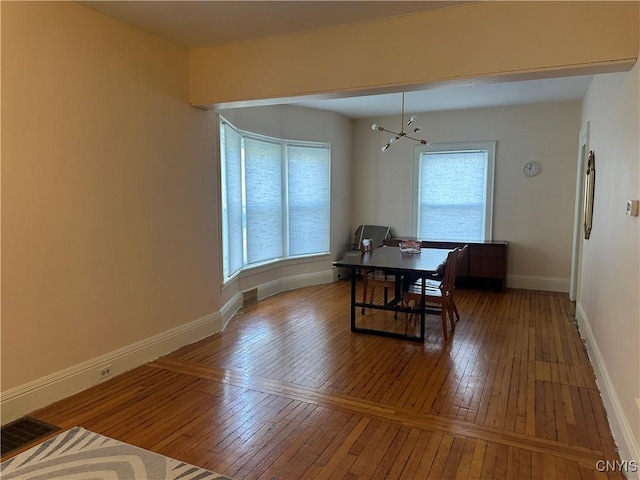 101 Avondale Pl, Syracuse, NY 13210 - dining area featuring hardwood / wood-style flooring, plenty of natural light, an office area, and a chandelier