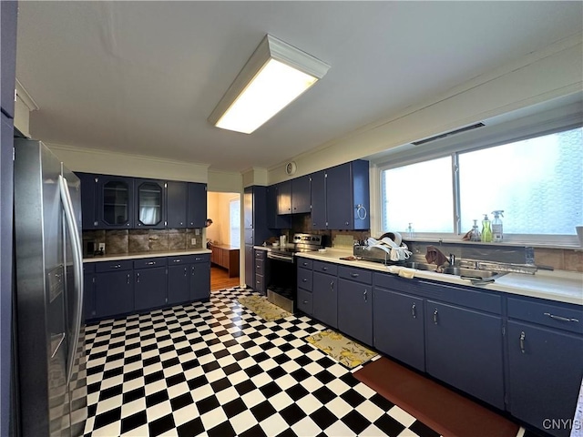 101 Avondale Pl, Syracuse, NY 13210 - kitchen featuring appliances with stainless steel finishes, tile patterned floors, light countertops, and decorative backsplash