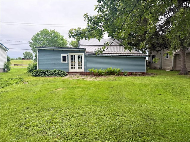 73 E River St, Fayette, NY 13165 - back of house with french doors, a yard, and a metal roof