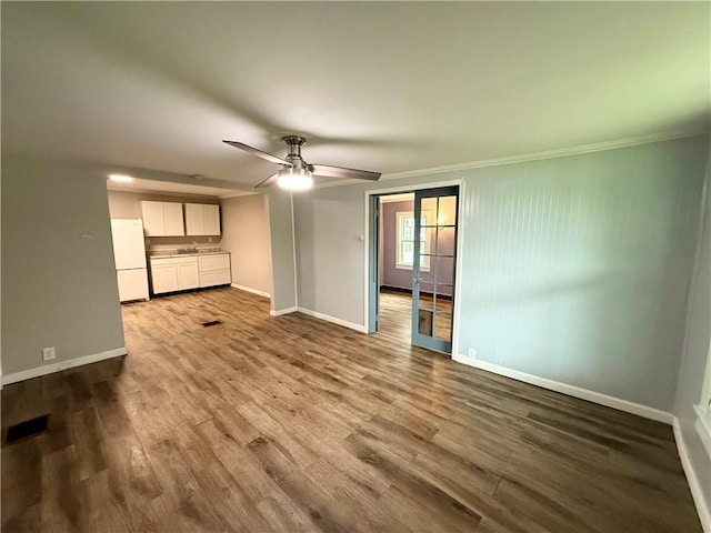 73 E River St, Fayette, NY 13165 - unfurnished living room featuring wood finished floors, ceiling fan, and crown molding