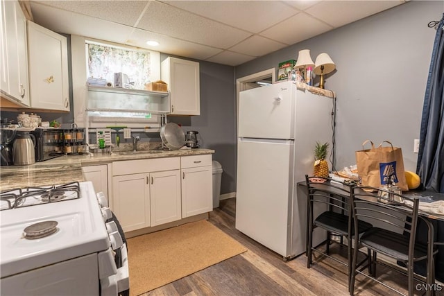 221.5 Lakeview Ave, Syracuse, NY 13204 - kitchen featuring white appliances, white cabinets, light wood-style floors, and a drop ceiling