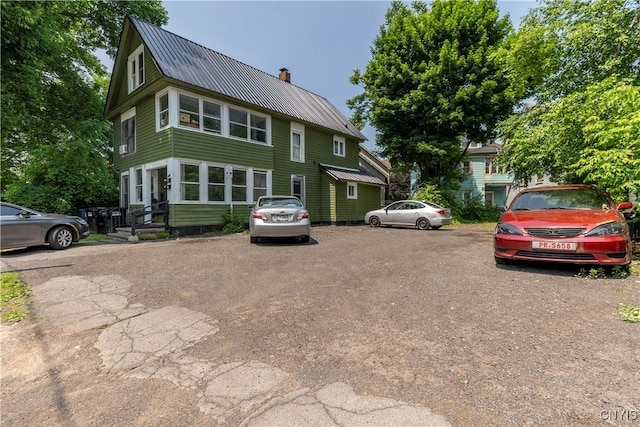 220 Lakeview Ave, Syracuse, NY 13204 - view of front facade featuring a chimney, uncovered parking, and a metal roof