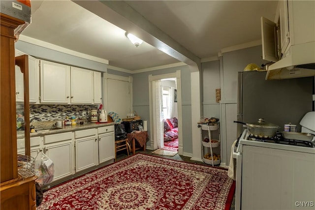 220 Lakeview Ave, Syracuse, NY 13204 - kitchen featuring white range with gas stovetop, backsplash, under cabinet range hood, white cabinets, and crown molding