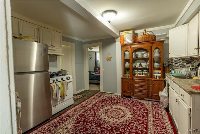 220 Lakeview Ave, Syracuse, NY 13204 - kitchen featuring white range with gas stovetop, freestanding refrigerator, under cabinet range hood, white cabinetry, and light countertops