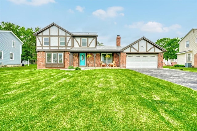 21 Wethersfield Rd, Chili, NY 14624 - english style home with brick siding, asphalt driveway, a chimney, and a garage