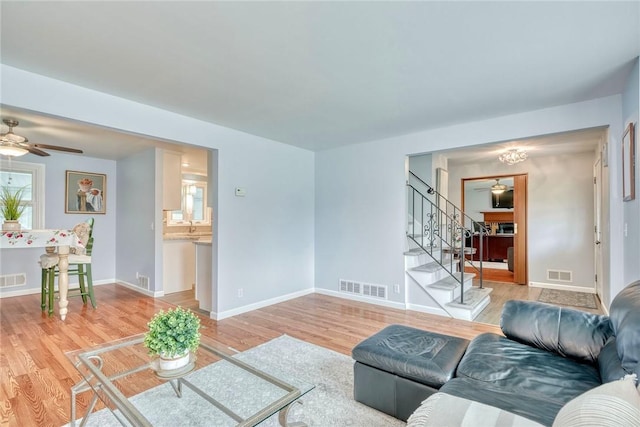 21 Wethersfield Rd, Chili, NY 14624 - living room with ceiling fan, stairway, and light wood finished floors