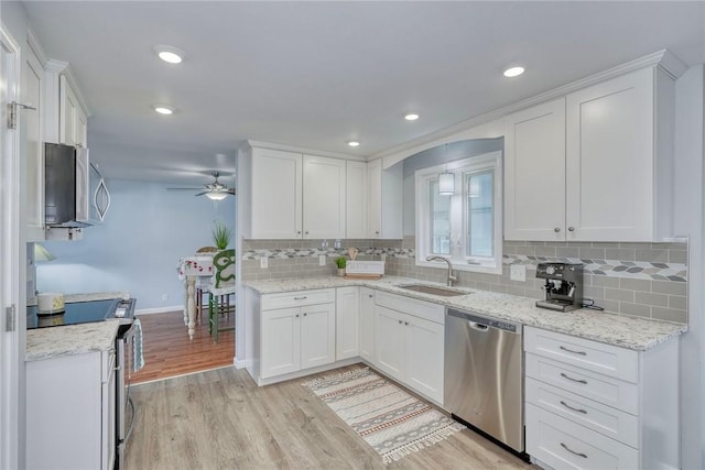 21 Wethersfield Rd, Chili, NY 14624 - kitchen featuring appliances with stainless steel finishes, a ceiling fan, white cabinetry, light wood-type flooring, and tasteful backsplash