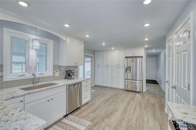 21 Wethersfield Rd, Chili, NY 14624 - kitchen with appliances with stainless steel finishes, white cabinets, light wood-style flooring, tasteful backsplash, and recessed lighting