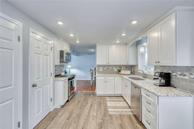 21 Wethersfield Rd, Chili, NY 14624 - kitchen with appliances with stainless steel finishes, light wood-type flooring, white cabinets, backsplash, and recessed lighting