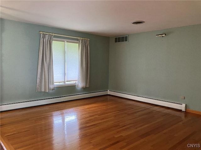 462 Hacadam Rd, Frankfort, NY 13456 - unfurnished room with wood finished floors and a baseboard radiator