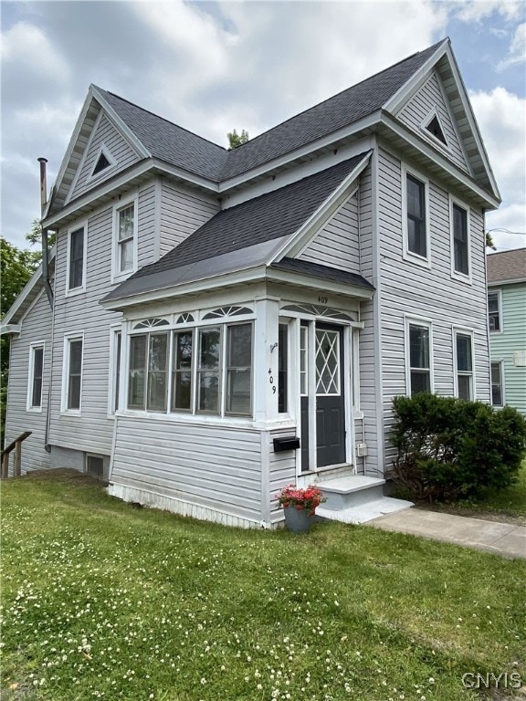 409 W 1st St S, Fulton, NY 13069 - view of front of property with a front lawn and a shingled roof