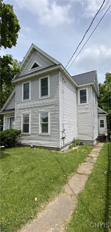 409 W 1st St S, Fulton, NY 13069 - view of side of property featuring a yard and entry steps